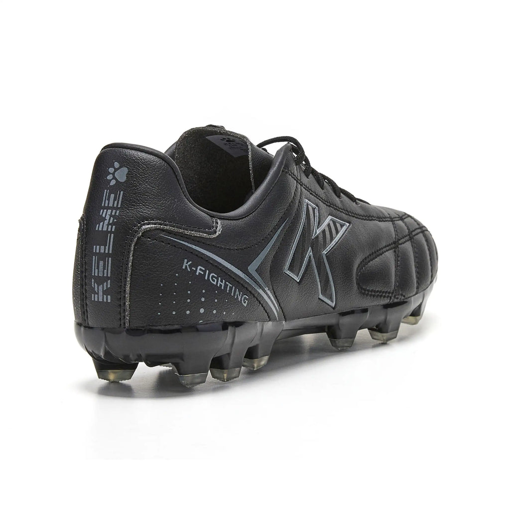 Kelme New Millenia Black Soccer Boots - 100% synthetic leather, modern design, lightweight for speed, with traction technology for optimal grip, perfect for players of all levels in Spring/Summer 2025.